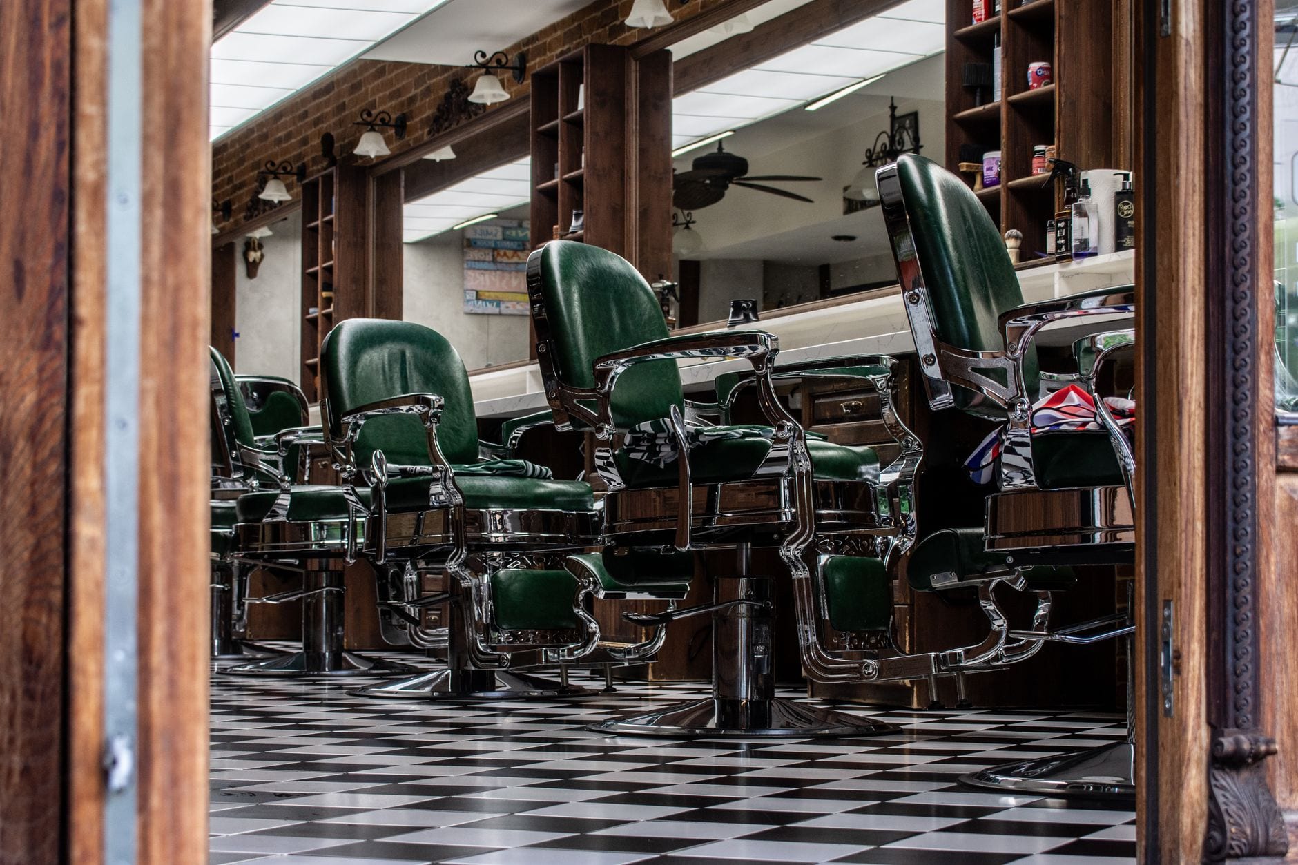 Row of classic barber chairs in a vintage barbershop with a checkered floor